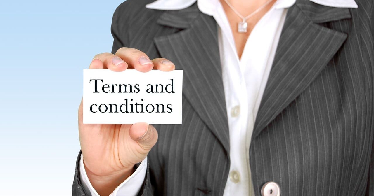 Terms & Conditions 1 A professional woman in a pinstripe suit holding a white card that reads "Terms and conditions" against a light blue background.
